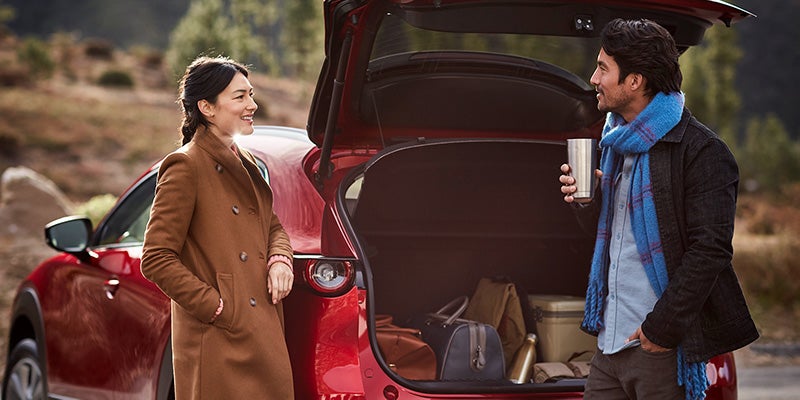 Couple talking next to their 2020 Mazda CX-30